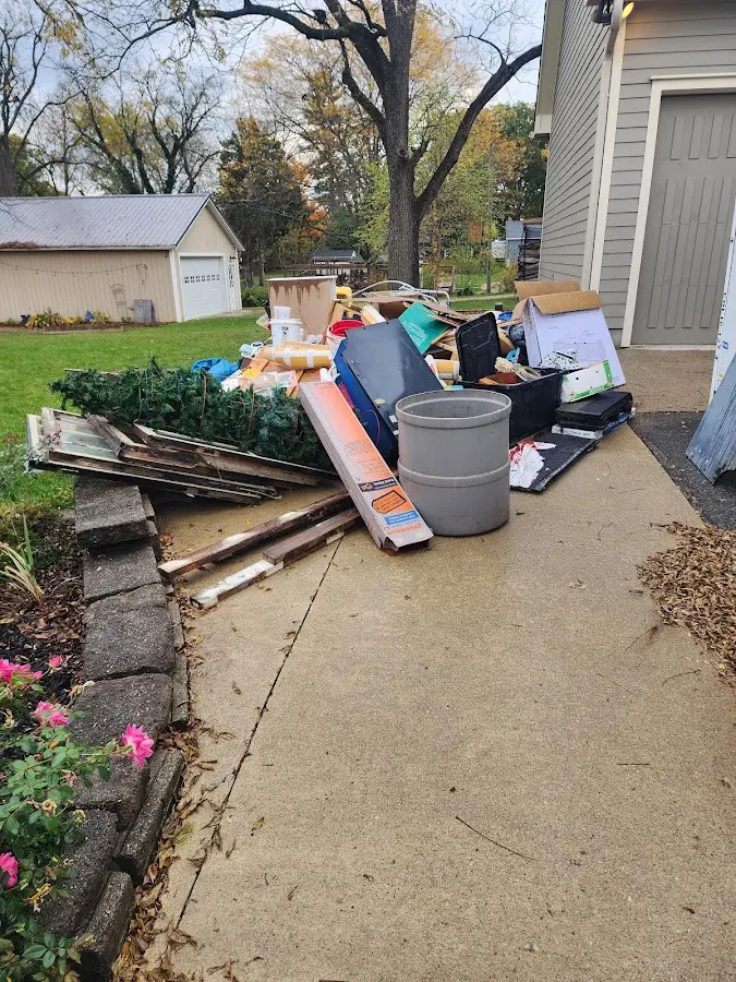 Dumpster being loaded with debris for Estate Cleanout Dumpster Rental in Cameron Park